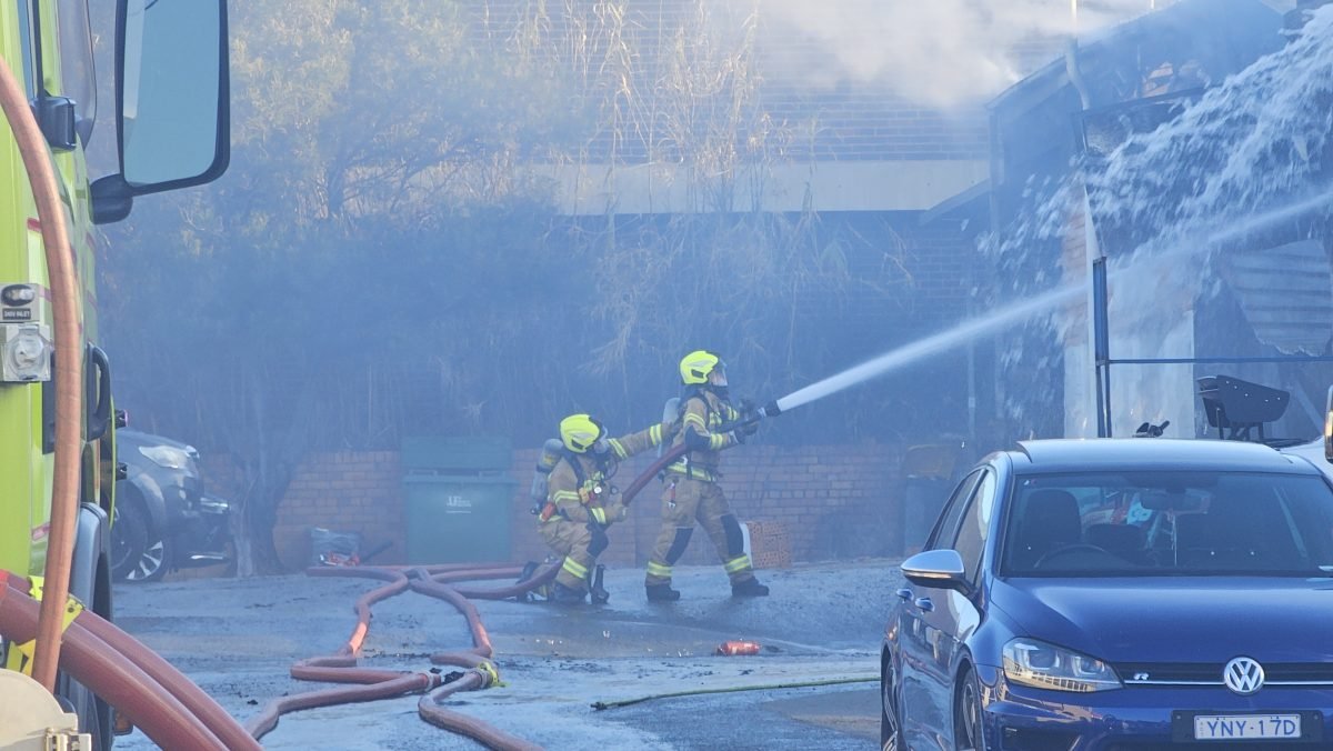 ‘There’s like fire all on the floor of the garage here’: fire brings down roof of Fyshwick business